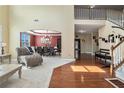 Bright foyer featuring hardwood floors, a staircase, and an open view to the dining room at 3798 Broadleaf Walk, Snellville, GA 30039