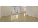 Spacious living area with hardwood floors, large windows, and French doors offering lots of natural light at 1445 Monroe Ne Dr # C6, Atlanta, GA 30324