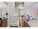 Open foyer with hardwood floors, a staircase, and views into the living and dining areas at 3452 Hard Creek Ln, Buford, GA 30519