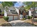 Lovely two-story home with a two-car garage, manicured lawn, and brick and siding exterior at 3452 Hard Creek Ln, Buford, GA 30519