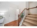 Inviting foyer features hardwood floors, a staircase, and a closet for storage at 114 Oakview Psge, Canton, GA 30114