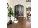 Elegant foyer with hardwood floors, grand staircase, and ornate wrought iron details at 3511 Roxboro Ne Rd, Atlanta, GA 30326