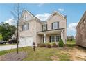 Attractive two-story brick home with a well-maintained lawn and a welcoming front porch at 795 Clark Lake Estates Dr, Grayson, GA 30017