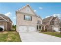 Charming two-story brick home featuring a two-car garage and a spacious driveway at 795 Clark Lake Estates Dr, Grayson, GA 30017