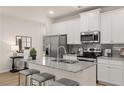 Bright kitchen featuring stainless steel appliances, granite countertops, and a kitchen island at 1012 Merritt Dr, Villa Rica, GA 30180
