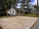 View of home featuring a large driveway, lush lawn and inviting outdoor space at 1938 Main Nw St, Atlanta, GA 30318