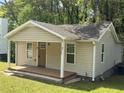 Newly renovated home featuring neutral siding, a welcoming porch, and well-maintained lawn at 1938 Main Nw St, Atlanta, GA 30318