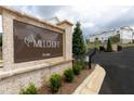 Elegant brick sign for Millcroft community, established in 2023, with lush landscaping and inviting entrance at 702 Dodd Ln # 159, Buford, GA 30518