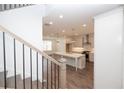View of new kitchen with large island and modern appliances from the stairway at 702 Dodd Ln # 159, Buford, GA 30518