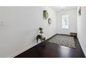 Bright entryway with wood floors, white walls, decorative accents, and a glass paneled front door at 4143 Halton Rd, Duluth, GA 30097