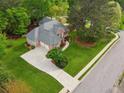 Aerial view of home featuring a spacious lot, attached garage, driveway, mature trees, and manicured lawn at 2060 Pate Ridge Dr, Loganville, GA 30052