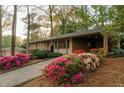Lovely home with a brick facade, sidewalk, and beautiful flowerbeds in the front yard create an inviting curb appeal at 2744 Hunting Hill Ln, Decatur, GA 30033