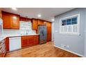 Stylish kitchen with wooden cabinets, stainless steel fridge, and white tile backsplash complementing modern appliances at 2744 Hunting Hill Ln, Decatur, GA 30033