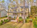 Charming two-story home with a welcoming front porch and beautifully landscaped front yard at 825 Clarion Way, Lawrenceville, GA 30044