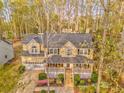 Charming two-story home with a welcoming front porch, two-car garage, and mature landscaping at 825 Clarion Way, Lawrenceville, GA 30044