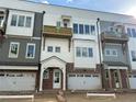 Close-up of newly constructed townhomes with brick accents and individual garage doors at 4209 Legacy Ln # 31, Acworth, GA 30101