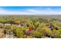Scenic aerial view of the property's location, nestled within a lush forest with glimpses of the city skyline at 115 Mount Paran Rdg, Atlanta, GA 30327