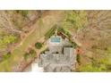 Aerial view of a luxury home with a private pool and meticulously landscaped backyard oasis at 115 Mount Paran Rdg, Atlanta, GA 30327