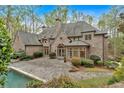 Luxury home featuring a brick exterior, in-ground pool, and patio at 115 Mount Paran Rdg, Atlanta, GA 30327