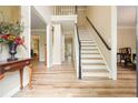 Inviting foyer with wood floors, staircase, neutral walls, and bright lighting at 3130 Crestmont Nw Way, Kennesaw, GA 30152