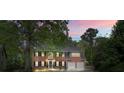 Beautiful brick home with mature landscaping, a circular driveway, and an attached two-car garage at 3130 Crestmont Nw Way, Kennesaw, GA 30152