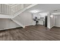 Open floor plan with hardwood floors, staircase, and kitchen with modern appliances at 41 Cantey Nw Pl, Atlanta, GA 30327