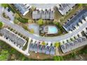 An aerial view showcases a residential community with a pool, surrounded by lush greenery and well-maintained homes at 5556 Cascade Sw Run, Atlanta, GA 30336