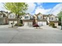 Charming townhomes with neat driveways, attached garages, and manicured landscaping on a quiet, tree-lined street at 5556 Cascade Sw Run, Atlanta, GA 30336