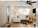 Cozy living room featuring a white sectional, hardwood floors, and a modern ceiling fan at 70 Sheridan Ne Dr # 10, Atlanta, GA 30305