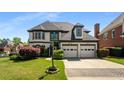 Elegant two-story home boasting a well-manicured lawn, two-car garage and manicured landscaping at 341 Declaire Ne Way, Marietta, GA 30067
