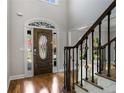 Grand foyer with hardwood floors, a stained-glass front door, and staircase with decorative iron spindles at 341 Declaire Ne Way, Marietta, GA 30067