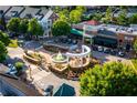 Aerial view of a vibrant town center with shops, restaurants, a fountain, and ample parking at 1548 Wicker Wood Se Pl, Smyrna, GA 30080