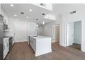 Well-lit kitchen featuring stainless steel appliances, a kitchen island, and wood floors throughout at 1080 Peachtree Ne St # 1504, Atlanta, GA 30309