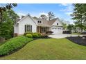 Beautiful home with charming curb appeal, featuring lush landscaping and a convenient two-car garage at 1127 Bank Se St, Smyrna, GA 30080