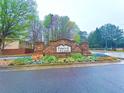 Parkway Villages entrance with a stone sign, colorful flowers, lush trees, and a welcoming neighborhood atmosphere at 5243 Cantbury Way, Atlanta, GA 30349