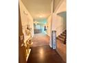Inviting foyer with hardwood floors, staircase, and a view to the living area at 5243 Cantbury Way, Atlanta, GA 30349