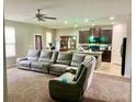 Open-concept living room featuring a large sectional sofa and view into the kitchen at 5243 Cantbury Way, Atlanta, GA 30349