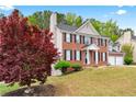 Attractive two-story brick home with black shutters and a well-maintained lawn at 642 Towering Pine Trl, Lawrenceville, GA 30045