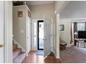 Bright foyer with staircase, coat closet, and view into living area with natural light at 726 Fir Chase, Fairburn, GA 30213