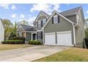 Charming two-story home with a manicured lawn and a two-car garage and stone detailing at 902 Brumley Nw Ln, Kennesaw, GA 30152