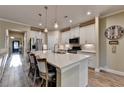 Open kitchen featuring a large island, stainless steel appliances, and pendant lighting at 230 Hickory Chase, Canton, GA 30115