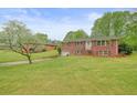 Well-maintained brick home with a spacious front lawn and mature landscaping at 2449 Fraser Rd, Marietta, GA 30066