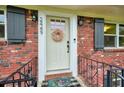 Charming brick home entrance with a welcoming wreath and decorative accents at 2449 Fraser Rd, Marietta, GA 30066