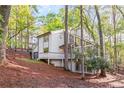 View of the house surrounded by trees and natural landscaping at 330 Spring Lake Ter, Roswell, GA 30076