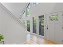 Bright and modern foyer featuring hardwood floors and tall windows at 330 Spring Lake Ter, Roswell, GA 30076
