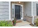 Inviting front door with sidelights, brick accents, and a cozy welcome mat at 4470 Madison Hall Dr, Cumming, GA 30028