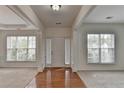 Bright foyer with hardwood floors, fresh paint, and a view of the surrounding rooms through large windows at 580 Hammersmith Dr, Suwanee, GA 30024