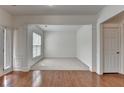 Spacious living room with hardwood floors, fresh paint, natural light, and an open layout at 580 Hammersmith Dr, Suwanee, GA 30024