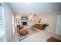 Bright living room featuring a fireplace, neutral walls, carpet and stylish decor at 909 Otter Ne Way, Marietta, GA 30068