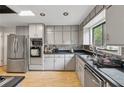 Kitchen featuring stainless steel appliances, light gray cabinetry, and modern countertops at 2470 Woodmere Dr, Marietta, GA 30068
